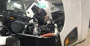Man servicing a Hino truck