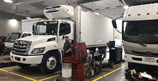 Two white Hino trucks