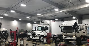 Two white Hino trucks