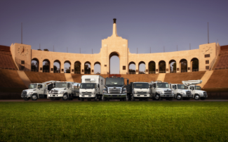 Lineup of Hino trucks in a stadium